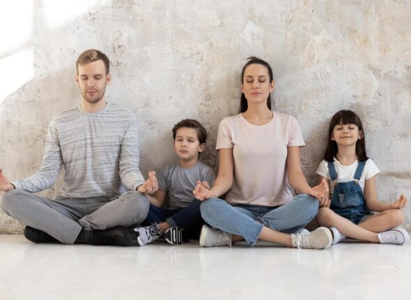 mindful-calm-happy-fit-family-young-parents-little-kids-sitting-together-heated-warm-wooden-floor-lotus-positions-meditation-practicing-breathing-yoga-exercises-wellness-hobby-concept_774935-1340